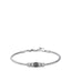 Silver-toned steel snake chain bracelet with a black enamel central element and textured cylindrical beads.