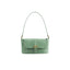 Front view of the BY FAR Miranda baguette bag in a light green croco-embossed leather featuring a matching shoulder strap and gold-tone buckle against a light grey background.