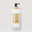Frosted white glass bottle of Creed Aventus Hand & Body Lotion with a black pump and gold-toned collar and label.