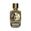 PARFUM DE MAHZEN Uchcha Extrait De Parfum in a clear glass bottle with olive green liquid, gold-toned cap, and ornate black a