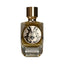 Clear glass perfume bottle with amber liquid, gold-toned cap, ornate black and white 'MA' monogram label. 'Divina' embossed o