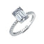 Silver-toned ring with a large clear emerald step-cut centre stone and smaller clear round stones pavé-set along the band.