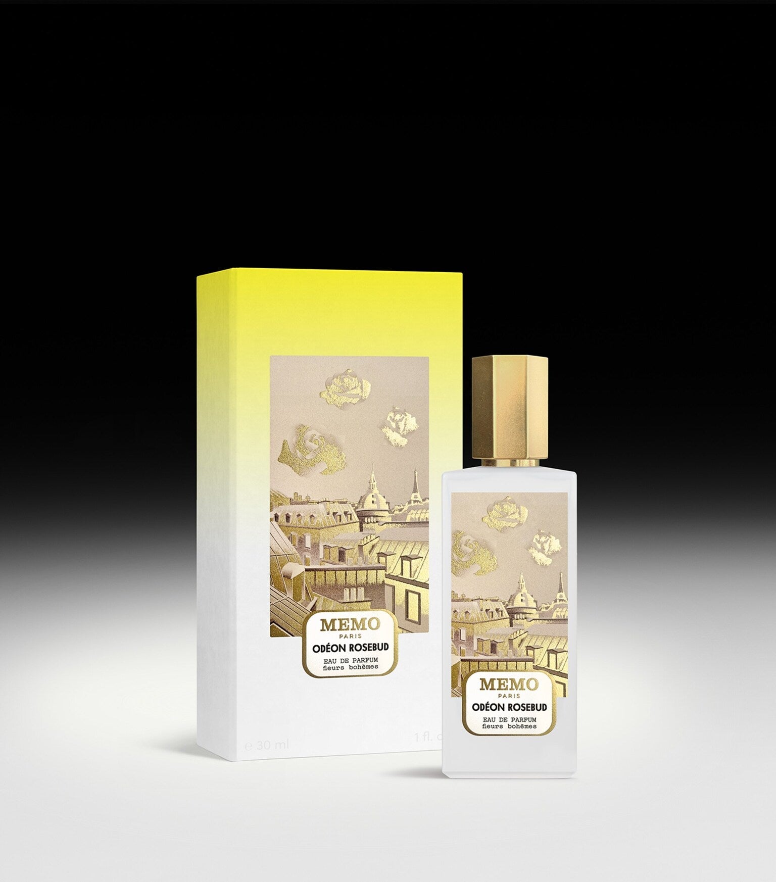 Frosted white rectangular perfume bottle with gold-toned cap and label showing Parisian rooftops and rosebuds. Matching yello
