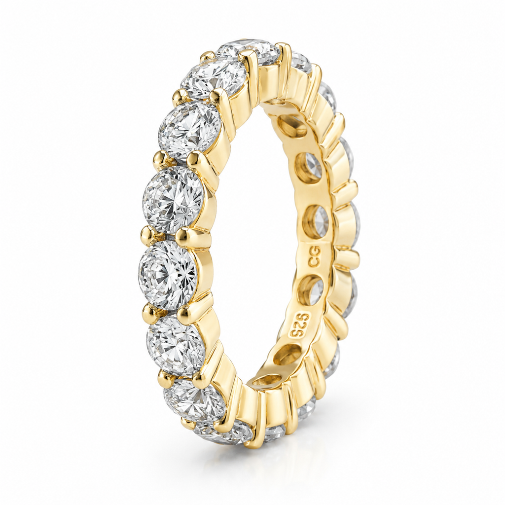 Gold-toned eternity ring with a full circle of clear, round cubic zirconia stones in a four-prong setting.