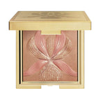 Sisley L'Orchidée face powder compact with a gold-toned case and an embossed floral design in bronze and pink shades.