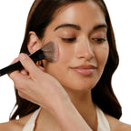Coral-pink pressed powder blush with a subtle sheen.