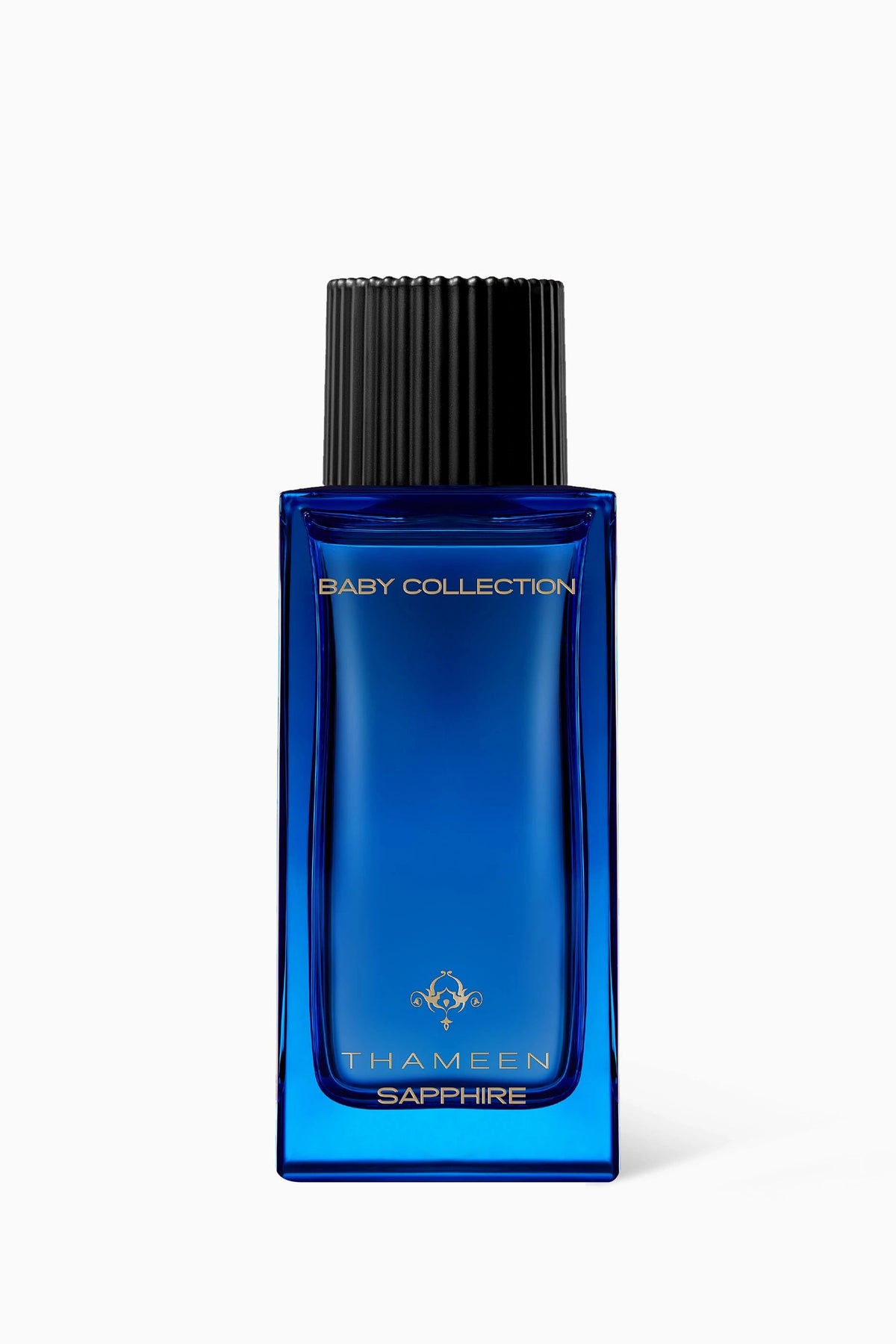 Thameen Sapphire Baby Fragrance in a rectangular blue glass bottle with a black ribbed cap and gold-toned lettering.