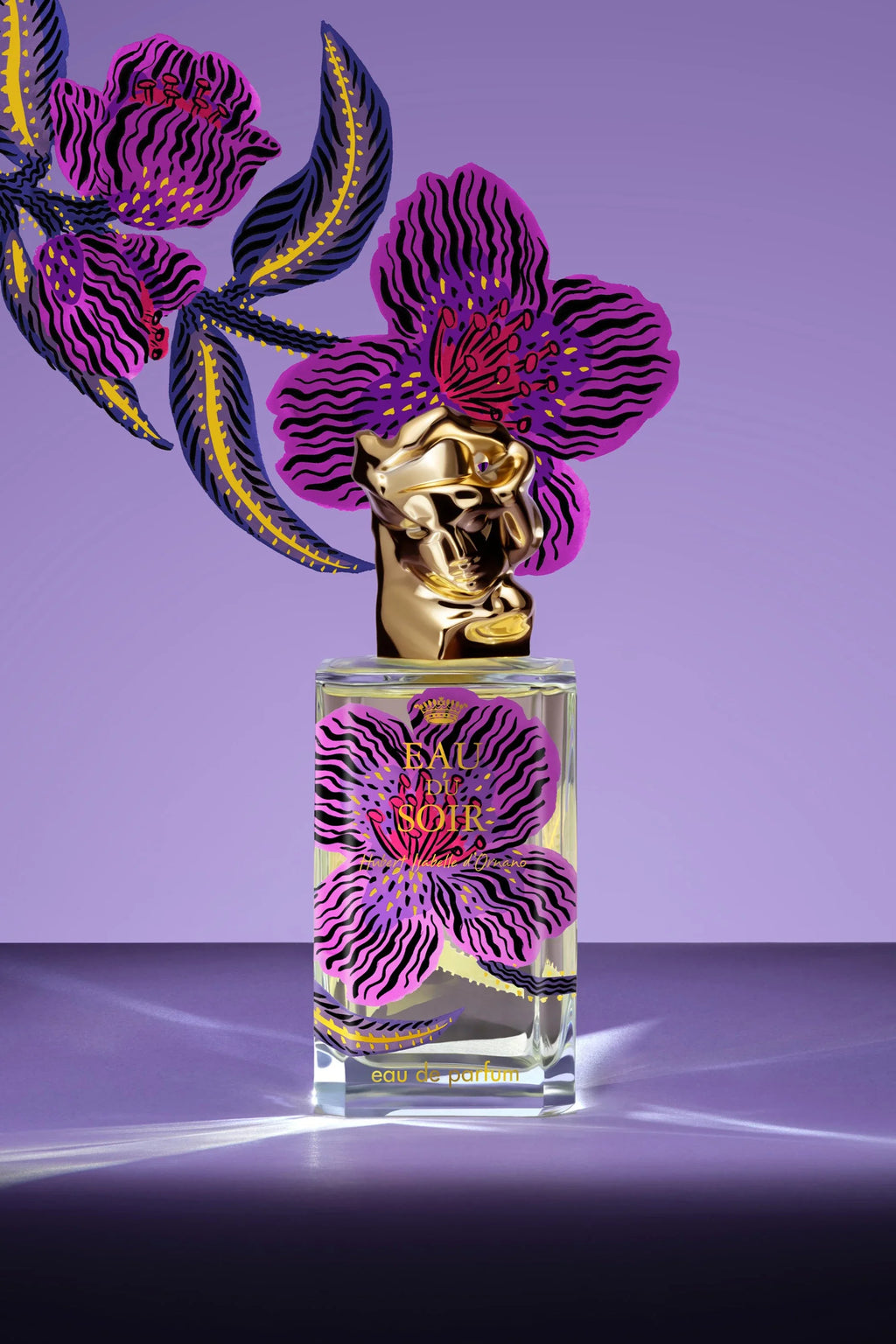 Clear rectangular perfume bottle with light yellow liquid. Purple orchid label with black wavy lines. Gold-toned sculpted bus