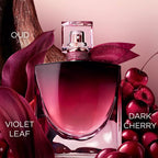 Clear glass perfume bottle with a cherry red gradient, a gold-toned sprayer, a sparkling red crystal collar, and a glittery r