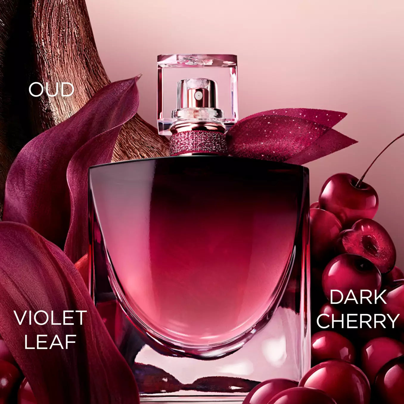 Clear glass perfume bottle with a cherry red gradient, a gold-toned sprayer, a sparkling red crystal collar, and a glittery r