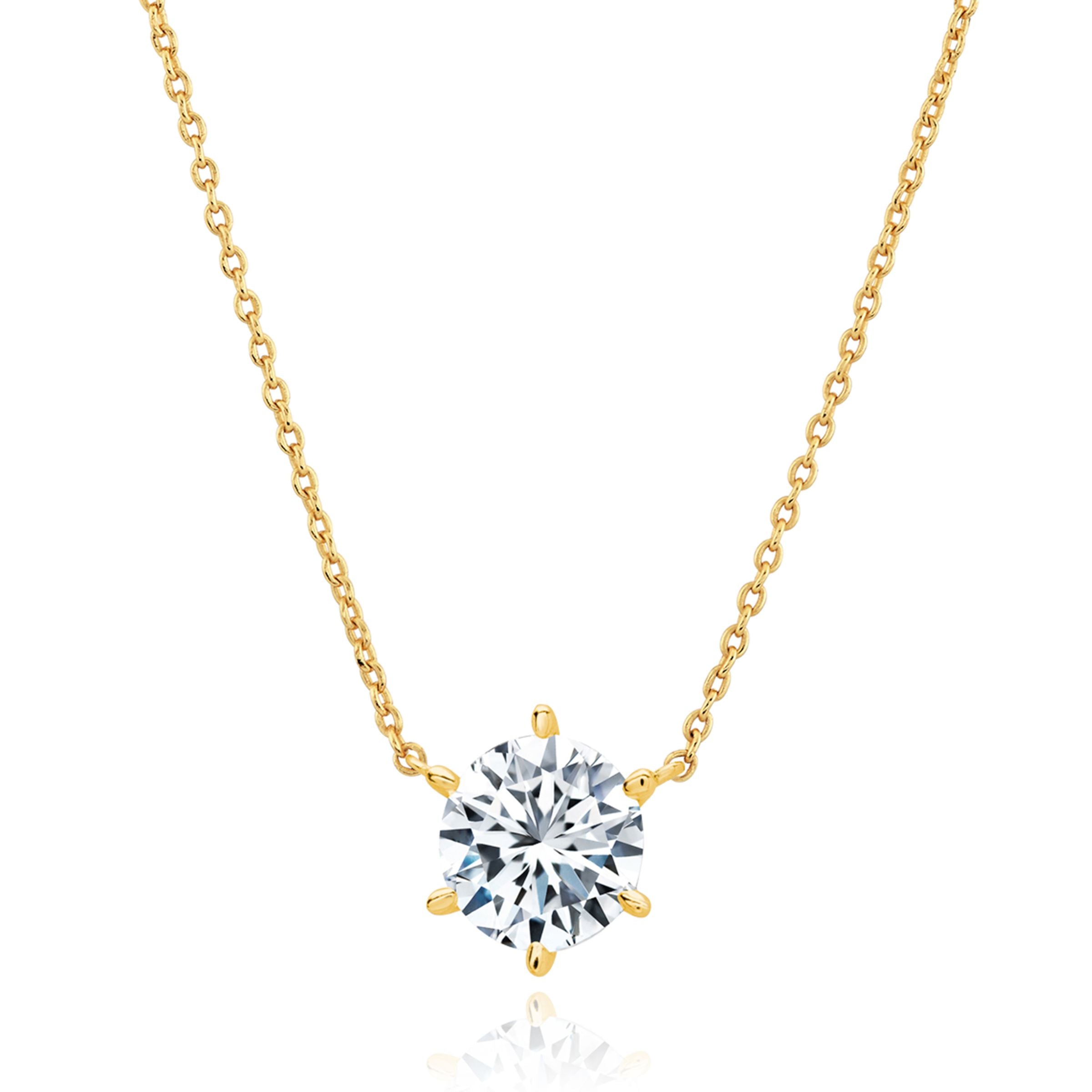 Yellow gold-toned cable chain necklace with a clear round faceted stone in a six-prong setting.