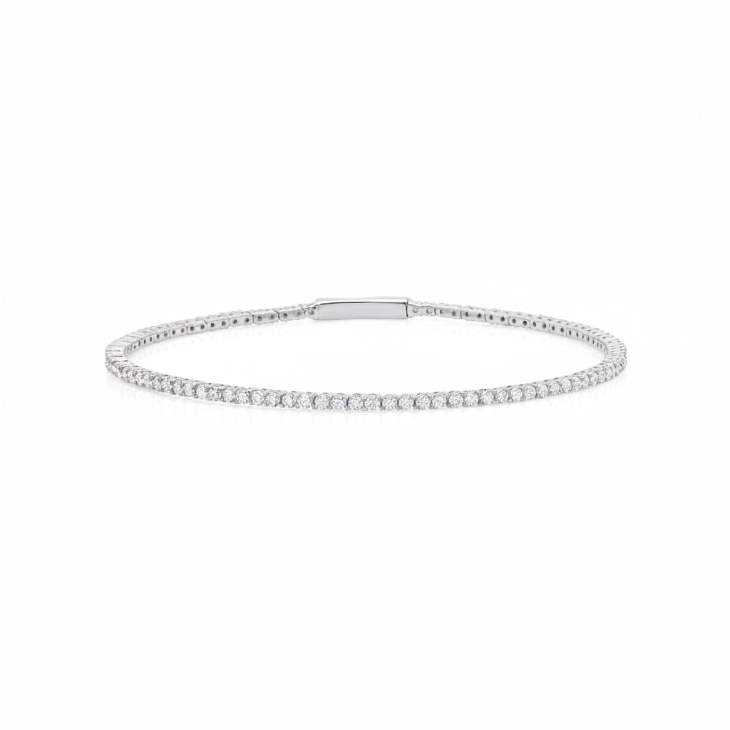 Silver-toned flexible tennis bracelet with a single row of clear, round stones and a flat bar clasp.