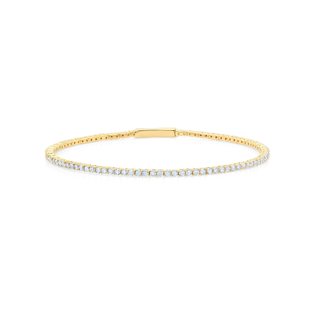 Gold-toned flexible tennis bracelet featuring a continuous line of small, round, clear stones and an integrated clasp.