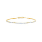 Gold-toned flexible tennis bracelet featuring a continuous line of small, round, clear stones and an integrated clasp.