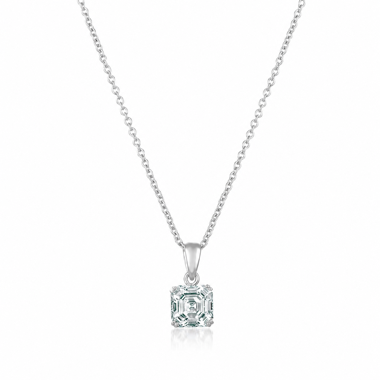 Silver-toned necklace with a delicate chain and a square, clear Asscher-cut pendant in a prong setting.