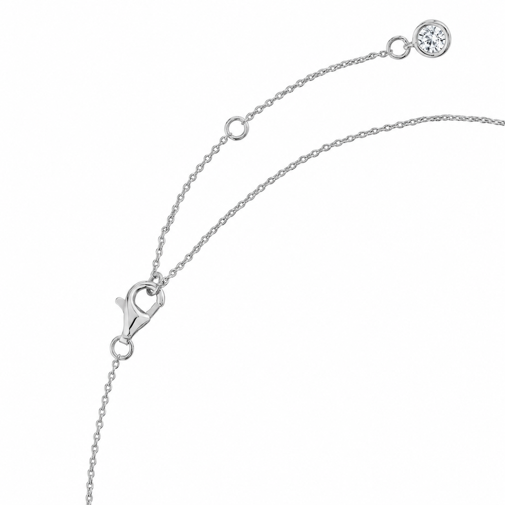 Silver-toned chain necklace with lobster clasp, extender chain, and a round clear stone at the end.