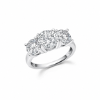 Silver-toned ring with three round, clear, faceted stones in a row, each secured by four prongs.