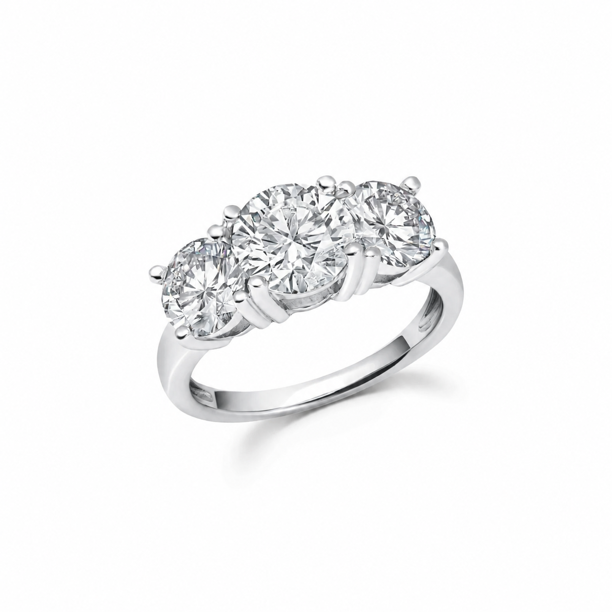 Silver-toned ring with three round, clear, faceted stones in a row, each secured by four prongs.