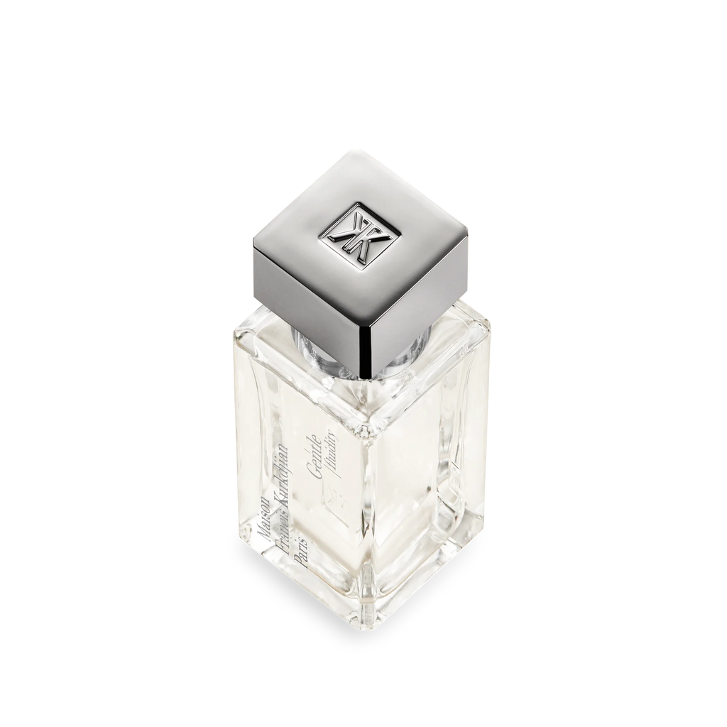 Clear rectangular glass perfume bottle with a silver-toned square cap featuring an embossed FK logo. Brand text on side.