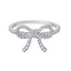 Silver-toned ring with a bow design, entirely encrusted with clear, brilliant-cut simulated diamonds.