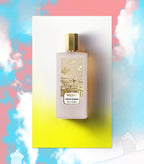 Frosted rectangular perfume bottle with a gold-toned hexagonal cap. Label features gold-toned Parisian cityscape and floating