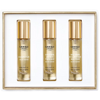 White gift set box containing three clear glass fragrance bottles with gold-toned caps and labels for Creed Aventus, Green Ir