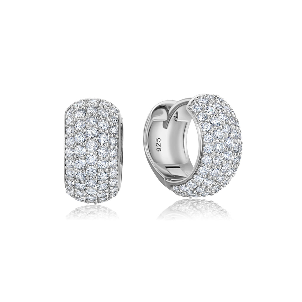Pair of silver-toned round hoop earrings, entirely covered in clear pave-set stones, with a hinged closure.