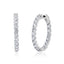 Pair of large round hoop earrings in silver-toned metal, each adorned with clear brilliant-cut stones.