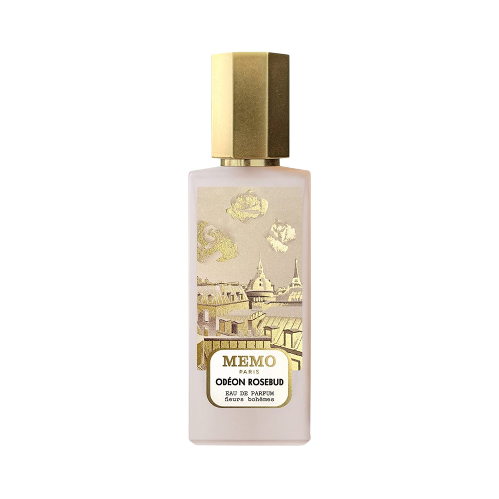Frosted rectangular perfume bottle with a gold-toned hexagonal cap and a label depicting a gold and cream Parisian cityscape