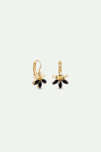 Pair of gold-toned sleeper earrings, each featuring a flower design with five black marquise-cut stones as petals.