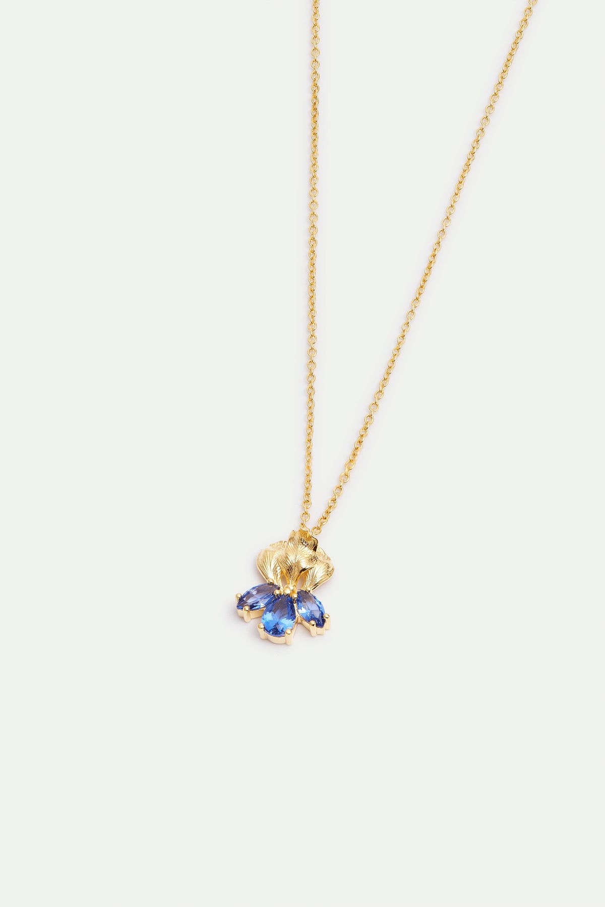 Gold-toned necklace with a textured fan-shaped pendant featuring three marquise-cut blue stones.
