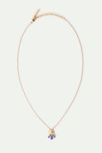 Delicate gold-toned necklace with a textured gold-toned pendant featuring a cluster of blue marquise-shaped stones.