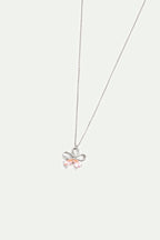 Silver-toned necklace with a flower-shaped pendant. The pendant has looped petals and two light pink teardrop-shaped stones.