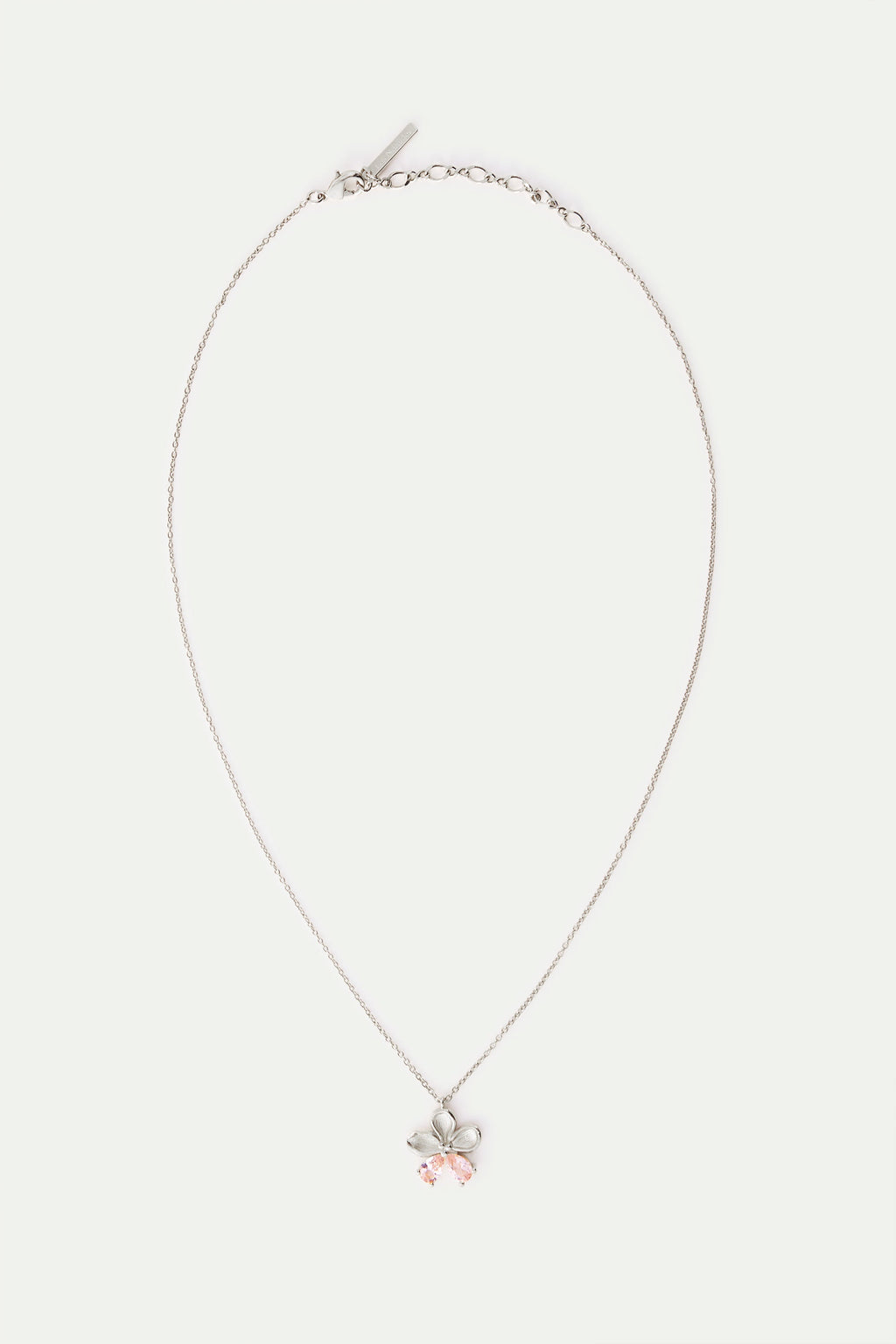 Silver-toned necklace with a flower pendant featuring five petals and two light pink teardrop stones.