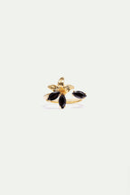 Gold-toned adjustable ring with a textured flower design, featuring three black marquise-cut stones and one separate black ma