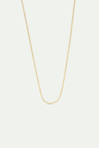 A delicate, gold-toned oval link chain necklace, draped in a U-shape.