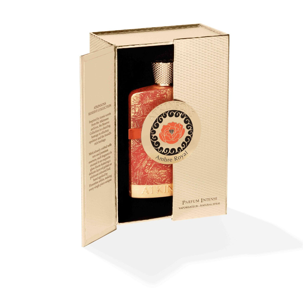Atkinsons Ambre Royal perfume bottle showcased inside an open premium gold textured presentation box revealing product details on the inside panel.