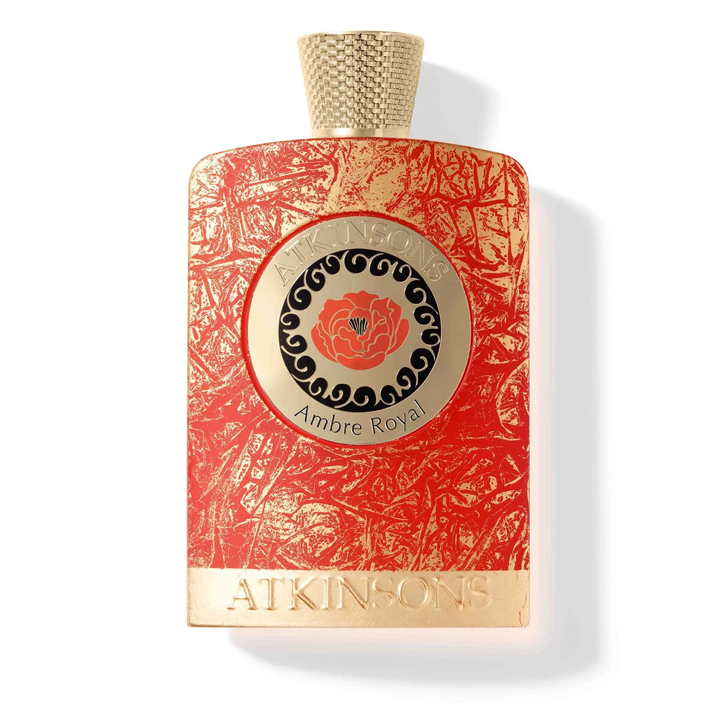 Gold and coral-red textured leaf patterned perfume bottle by Atkinsons featuring a central circular emblem with an orange floral design and "Ambre Royal" text.