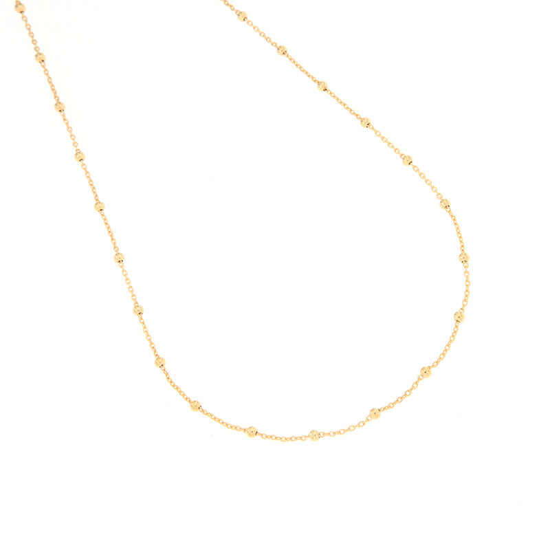 Gold-toned delicate chain necklace with evenly spaced, small, textured spherical beads.