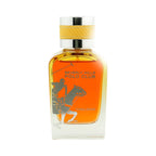 Clear glass perfume bottle with amber liquid, silver-toned polo player graphic, and a silver-toned cap with a textured yellow