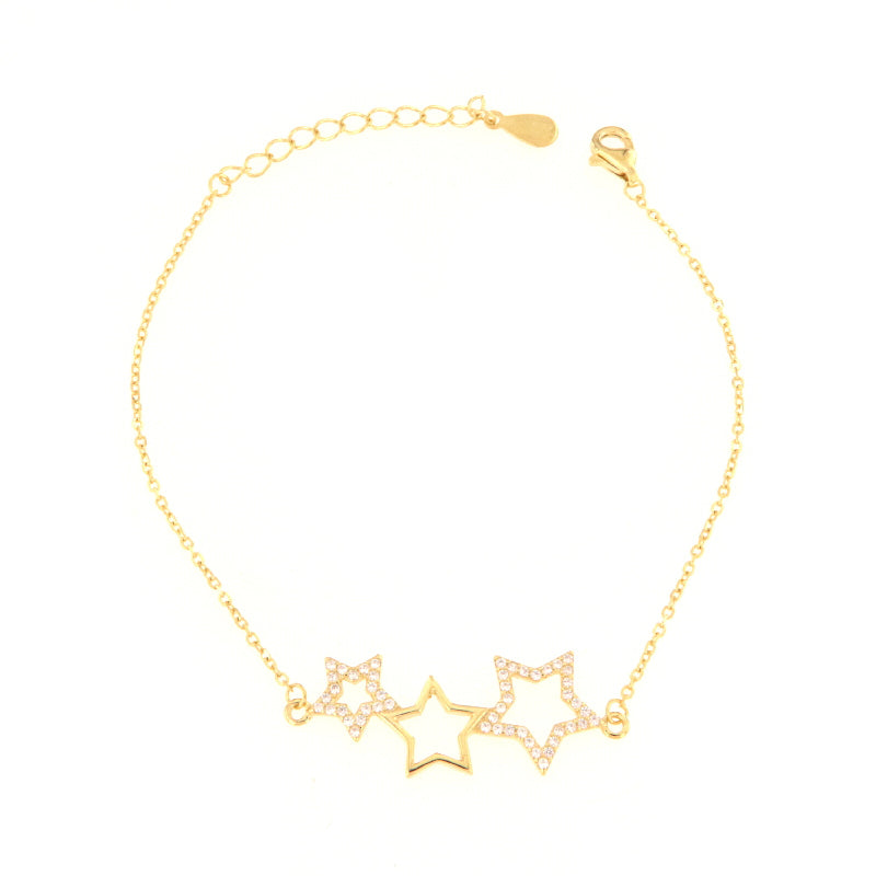 Gold-toned delicate chain bracelet with three star charms, two encrusted with clear stones and one plain outline.