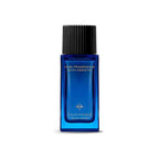 Blue rectangular glass bottle of hair fragrance with a black ridged cap and gold-toned emblem. Text reads "HAIR FRAGRANCE WIT