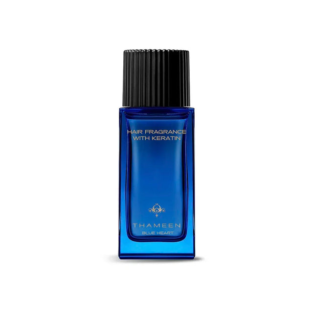 Blue rectangular glass bottle of hair fragrance with a black ridged cap and gold-toned emblem. Text reads "HAIR FRAGRANCE WIT