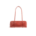 Front view of the BY FAR Kimberly shoulder bag in blood red nappa leather featuring a long rectangular body and two thin tubular straps against a light grey background.
