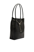 Side view of the BY FAR Kayla shoulder bag in black lambskin leather featuring a slouchy hobo silhouette, dual tubular straps, and a silver-tone chain toggle closure against a neutral background.