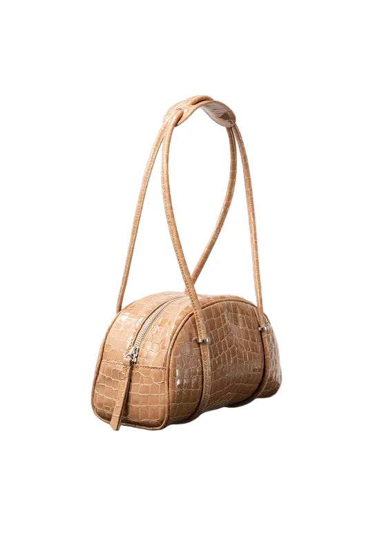 Side view of the BY FAR Kimberly Bowler shoulder bag in fresh green croco-embossed leather featuring a semi-circular body, two long tubular straps, and silver hardware accents.