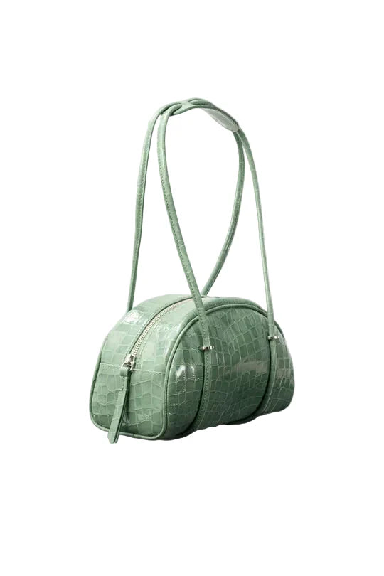 Side view of the BY FAR Kimberly Bowler shoulder bag in fresh green croco-embossed leather featuring a semi-circular body, two long tubular straps, and silver hardware accents.