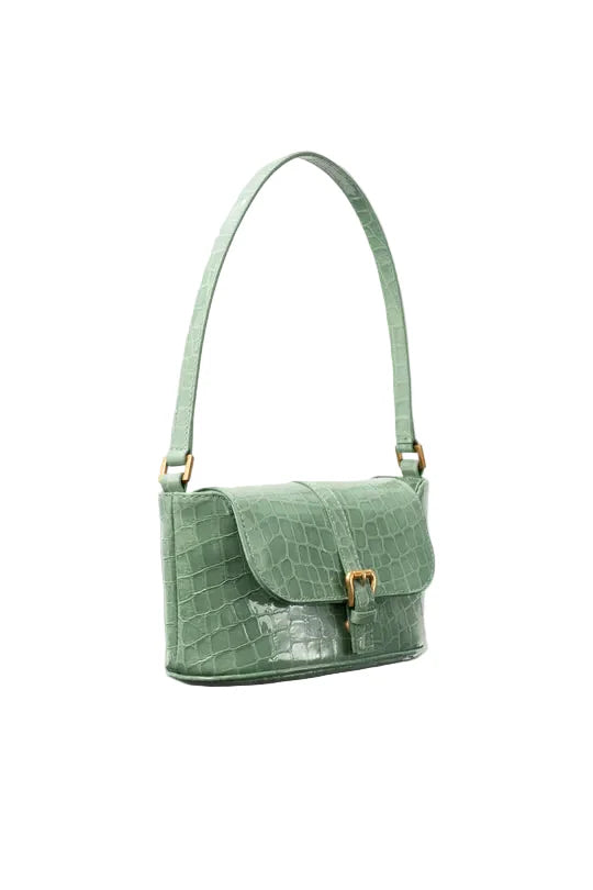 side view of the BY FAR Miranda baguette bag in a light green croco-embossed leather featuring a matching shoulder strap and gold-tone buckle against a light grey background.