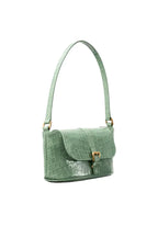 side view of the BY FAR Miranda baguette bag in a light green croco-embossed leather featuring a matching shoulder strap and gold-tone buckle against a light grey background.