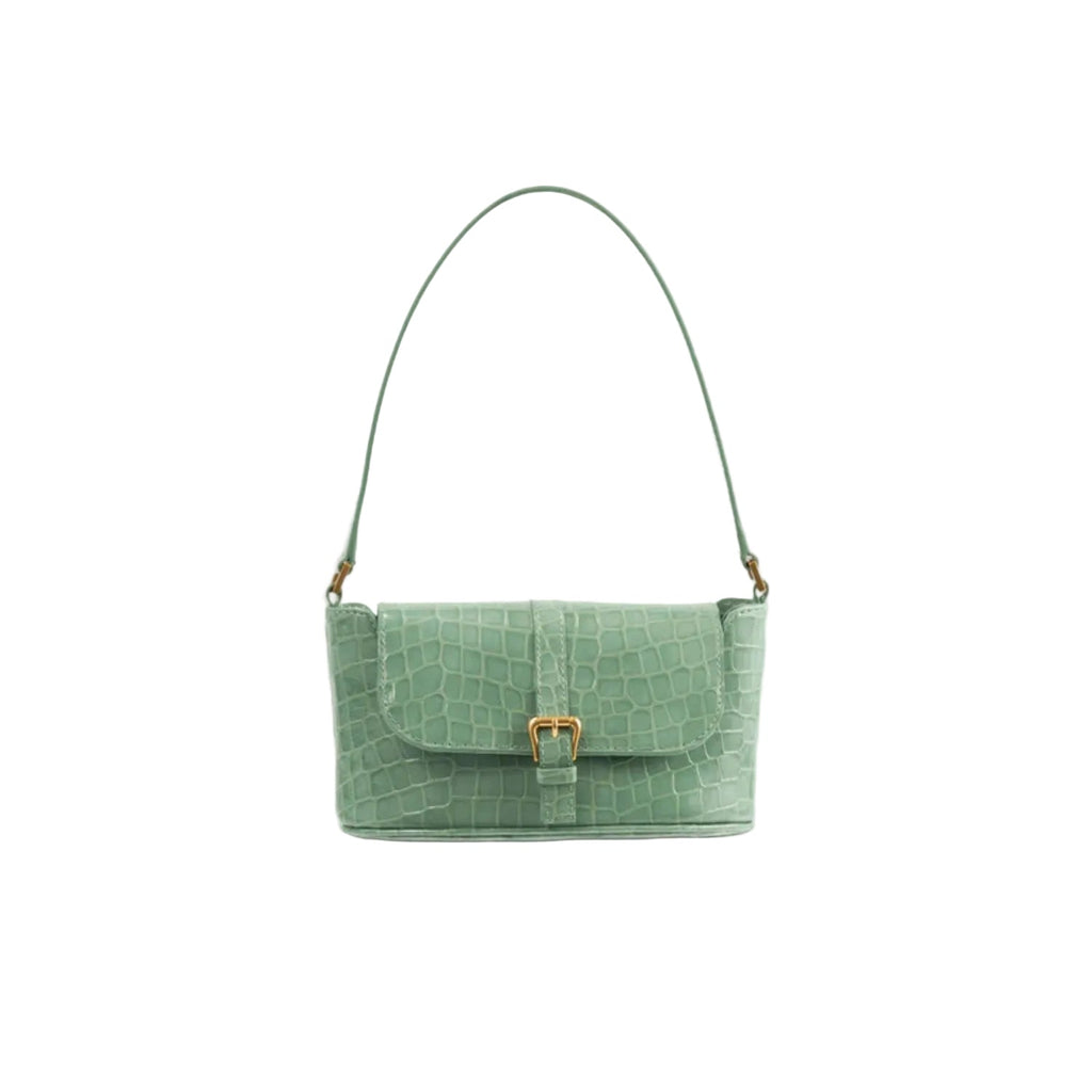 Front view of the BY FAR Miranda baguette bag in a light green croco-embossed leather featuring a matching shoulder strap and gold-tone buckle against a light grey background.